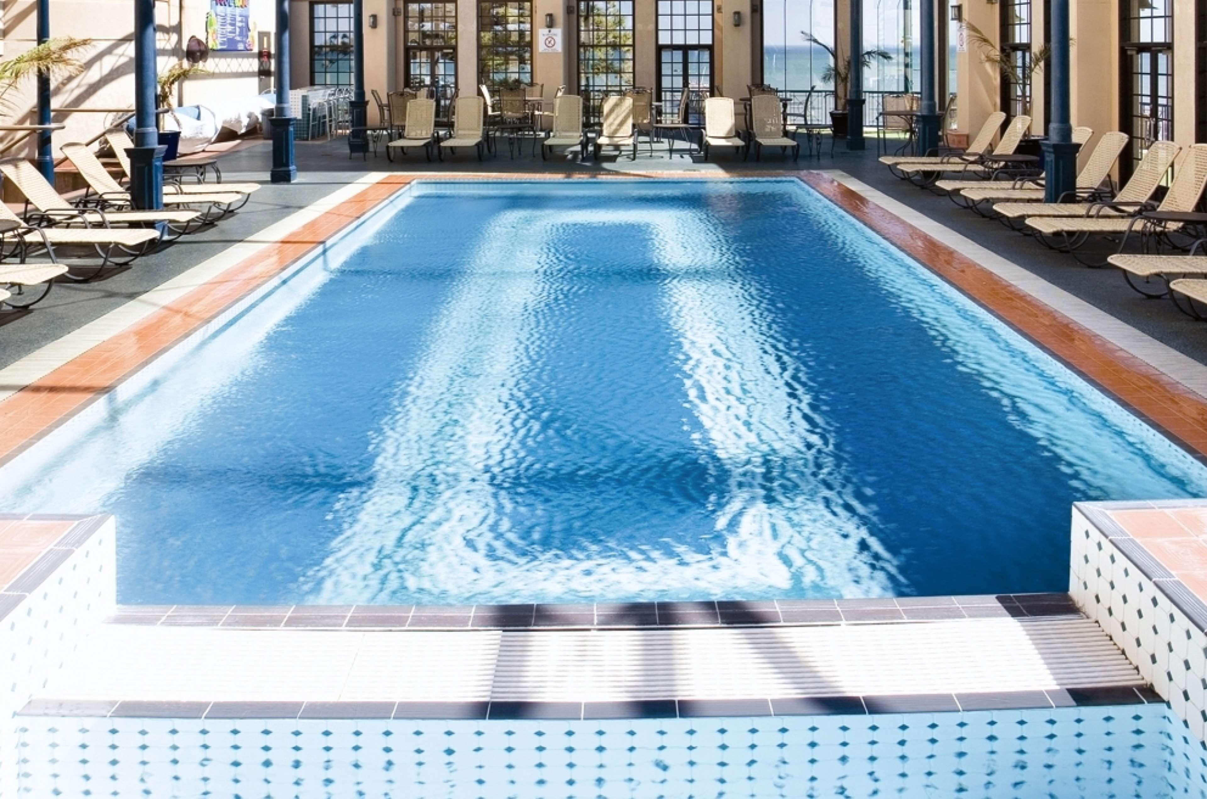 מלון גלנלג Stamford Grand Adelaide מראה חיצוני תמונה The photo shows an indoor swimming pool with a pristine blue surface. The pool is surrounded by a tiled deck and has lounge chairs lined up along the sides. Large windows allow natural light to flood the area, creating a bright and inviting atmospher
